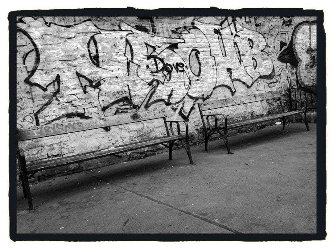 Bench in a graffiti wall